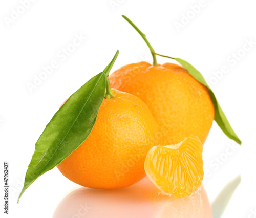 Photo: Ripe sweet tangerine with leaves, isolated on white Ripe sweet tangerine with leaves, isolated on white
