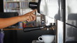 Barista making single espresso shot in white mug