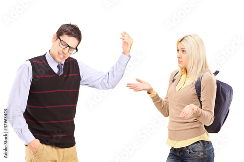 Photo: Young male and female student arguing Young male and female student arguing