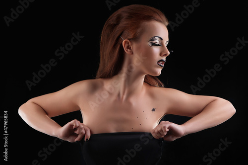 Photo: Fashion girl posing on dark background - portrait Fashion girl posing on dark background - portrait