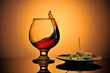 Glass of cognac with cheese plate