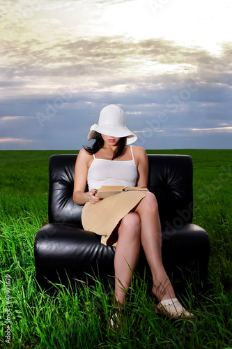 Photo: A woman reading a book A woman reading a book