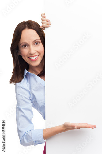 Photo: Young woman with blank poster Young woman with blank poster
