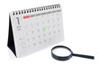Desk Calendar and magnifier isolated on white