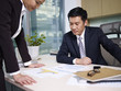 manager reviewing business with subordinate