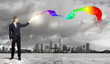 Businessman with colourful light beam in his hands