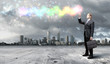 Businessman with colourful light beam in his hands