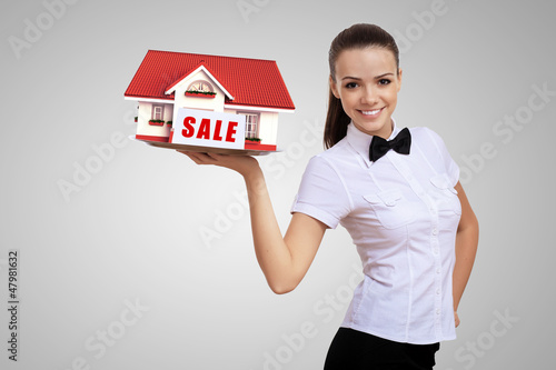 Photo: Waitress holding a tray with a house on it Waitress holding a tray with a house on it