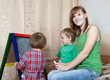 Photo: Woman and children draws on blackboard Woman and children draws on blackboard