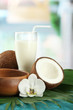 Coconut with glass of milk,  on blue wooden table