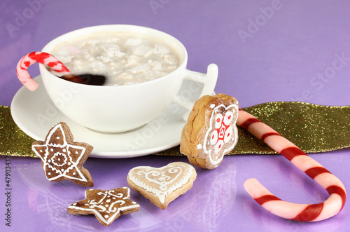 Photo: Cup of coffee with Christmas sweetness on purple background Cup of coffee with Christmas sweetness on purple background