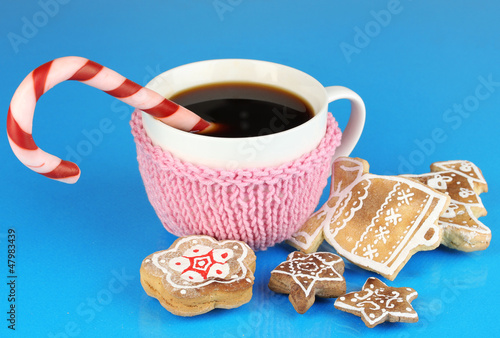 Photo: Cup of coffee with Christmas sweetness on blue background Cup of coffee with Christmas sweetness on blue background