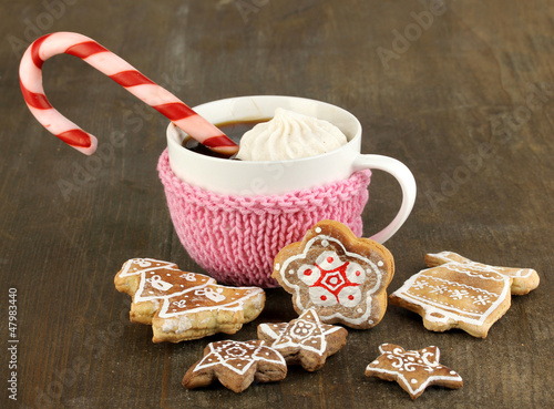 Photo: Cup of coffee with Christmas sweetness on wooden table close-up Cup of coffee with Christmas sweetness on wooden table close-up