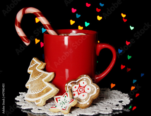 Photo: Cup of coffee with holiday candy on Christmas lights background Cup of coffee with holiday candy on Christmas lights background