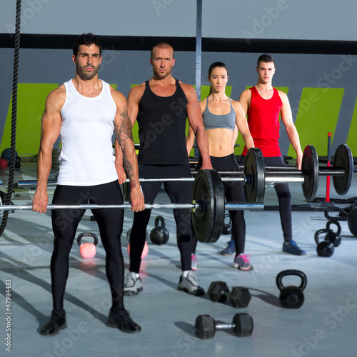 Photo: gym group with weight lifting bar crossfit workout gym group with weight lifting bar crossfit workout