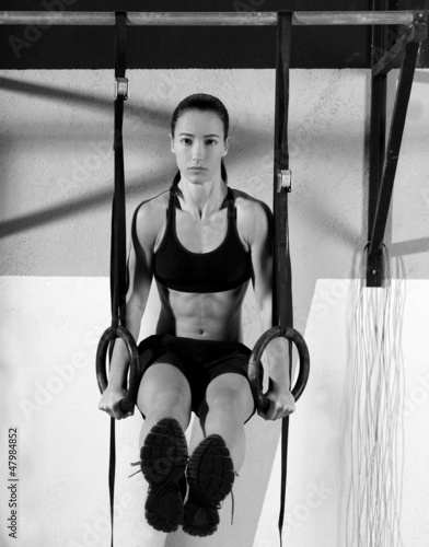 Photo: Crossfit dip ring woman workout at gym dipping Crossfit dip ring woman workout at gym dipping
