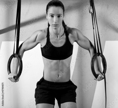 Photo: Crossfit dip ring woman workout at gym dipping Crossfit dip ring woman workout at gym dipping