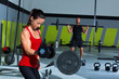 girl dumbbell and man weight lifting bar workout