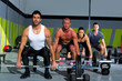 gym group with weight lifting bar crossfit workout