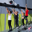 Crossfit workout people group with wall balls and rope