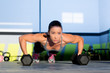 Gym woman push-up strength pushup with dumbbell