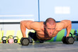 Gym man push-up strength pushup with dumbbell