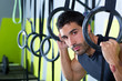 Crossfit dip ring man relaxed after workout at gym