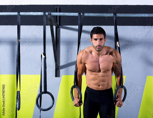 Photo: Crossfit dip ring man workout at gym Crossfit dip ring man workout at gym