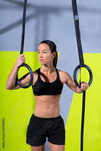 Photo: Crossfit dip ring woman relaxed after workout at gym Crossfit dip ring woman relaxed after workout at gym