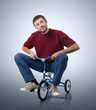 Dreams of a man on a children's bicycle