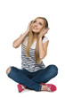 Photo: Female sitting on floor enjoying music in headphones Female sitting on floor enjoying music in headphones