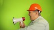 Foreman shouting into a megaphone on a green background