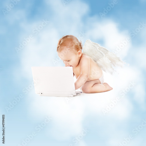 Photo: little angel with laptop computer little angel with laptop computer