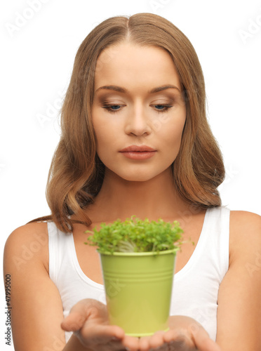 Photo: woman with green grass in pot woman with green grass in pot