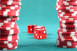 red poker gambling chips on a green playing table