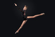 Young woman in gymnast suit posing