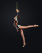 Young woman in gymnast suit posing