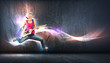 young woman playing on electro guitar and jumping