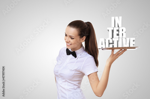 Photo: Waitress holding a tray with word interactive Waitress holding a tray with word interactive