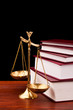 books of justice and scale on wooden table