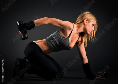 Photo: Fit woman exercising with weights Fit woman exercising with weights