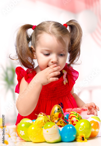 Photo: girl paints eggs girl paints eggs