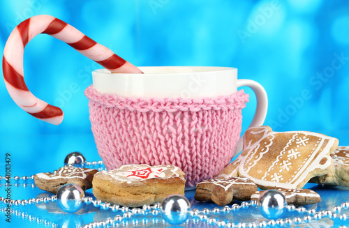 Photo: Cup of coffee with Christmas sweetness on blue background Cup of coffee with Christmas sweetness on blue background