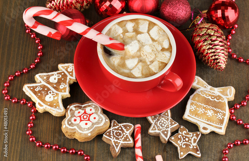 Photo: Cup of coffee with Christmas sweetness on wooden table close-up Cup of coffee with Christmas sweetness on wooden table close-up