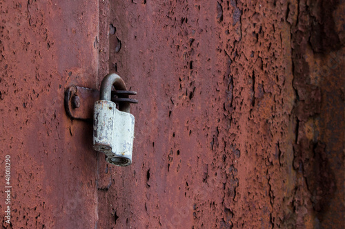 Photo: Closed metal lock door security protection padlock Closed metal lock door security protection padlock