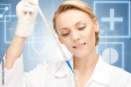 Photo: lab worker holding up test tube lab worker holding up test tube