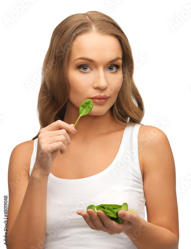 Photo: woman with spinach leaves on palms woman with spinach leaves on palms