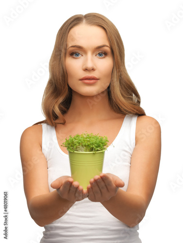 Photo: woman with green grass in pot woman with green grass in pot