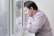 Courageous middle age man looking at the window