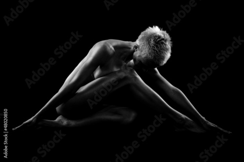 Photo: Naked woman on black background Naked woman on black background